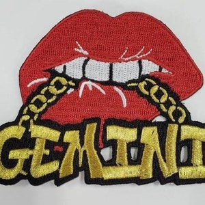 May include: A red embroidered patch with a large, open mouth with white teeth and a gold chain. The words "GEMINI" are embroidered in gold on a black background.