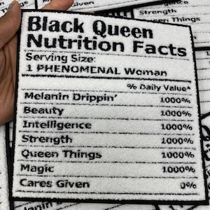 May include: A white and black rectangular patch with the text "Black Queen Nutrition Facts". The patch lists "Melanin Drippin'", "Beauty", "Intelligence", "Strength", "Queen Things", "Magic", and "Cares Given" with 1000% values.