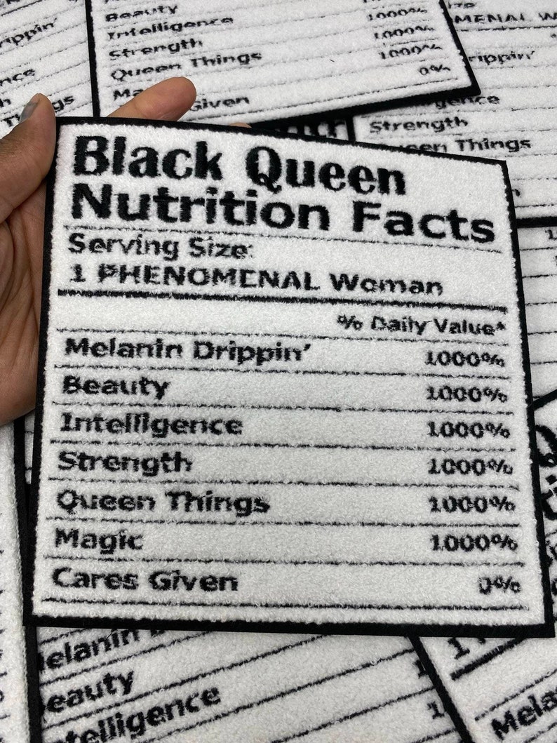 May include: A white and black rectangular patch with the text "Black Queen Nutrition Facts". The patch lists "Melanin Drippin'", "Beauty", "Intelligence", "Strength", "Queen Things", "Magic", and "Cares Given" with 1000% values.