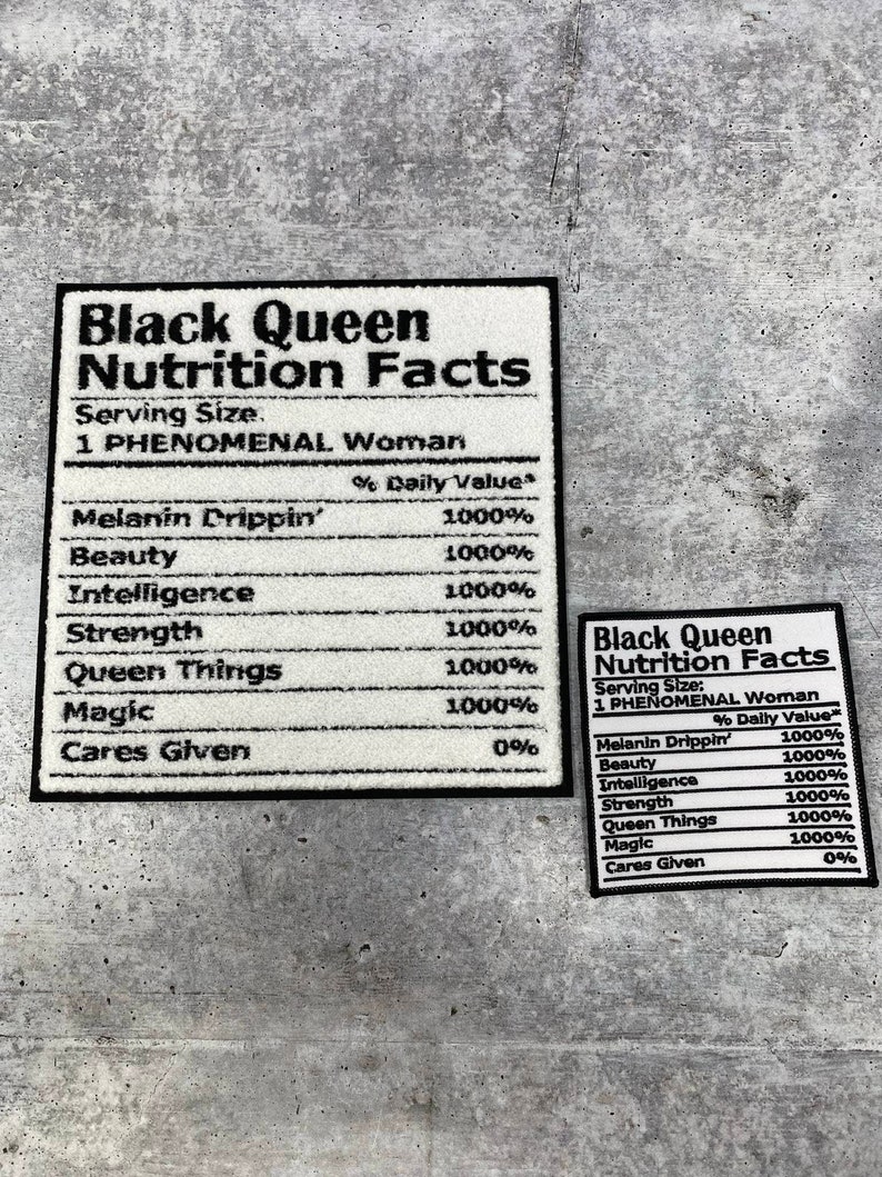 May include: Two white rectangular patches with black borders and text that reads "Black Queen Nutrition Facts." The larger patch lists "Melanin Drippin'," "Beauty," "Intelligence," "Strength," "Queen Things," and "Magic."