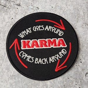 May include: Black round patch with white and red embroidery. The text reads "What goes around karma comes back around" with arrows pointing in a circle.
