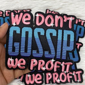 May include: A set of black iron-on patches with pink and blue embroidery. The patches feature the text "We don't gossip, we profit it".
