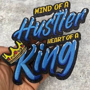 May include: Blue and yellow embroidered patch with the text "Mind of a Hustler Heart of a King" and a gold crown.