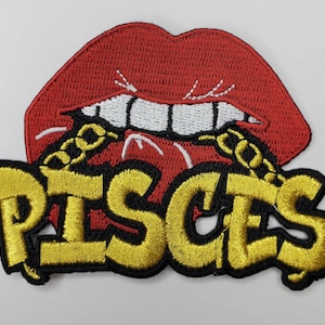 May include: Red lips with a gold chain and the word "Pisces" in gold letters on a black background.