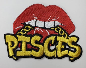 May include: Red lips with a gold chain and the word "Pisces" in gold letters on a black background.