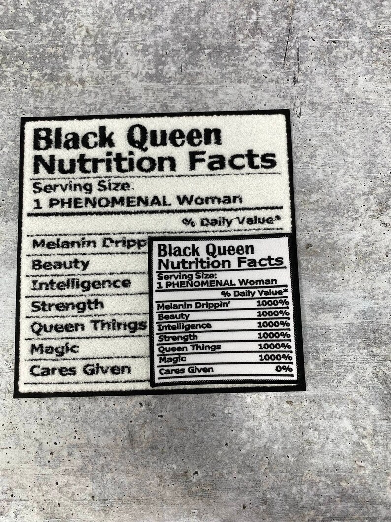 May include: A rectangular black and white patch featuring the text "Black Queen Nutrition Facts." The patch lists "Melanin Drippin'," "Beauty," "Intelligence," "Strength," "Queen Things," and "Magic" with 1000% daily value.