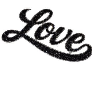 May include: A decorative script word sign reading Love in a black glitter finish. The lettering features a cursive font style with a thick, rounded outline and a dense, sparkling texture throughout the surface of the letters against a white background.