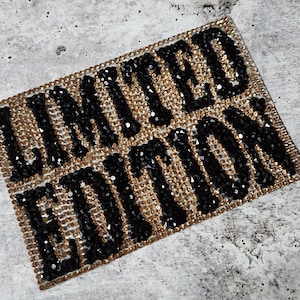 May include: A close-up of a black and gold rhinestone patch that reads "LIMITED EDITION".