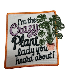 May include: A square embroidered patch with an orange border on a white background. It features the text "I'm the Crazy Plant lady you heard about!" in purple and black thread, alongside an embroidered green monstera plant in a pink pot.