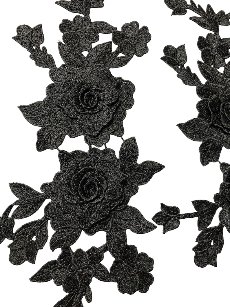 May include: Black embroidered floral applique featuring roses and other flowers with detailed leaves. The applique is made of a textured fabric, suitable for embellishing clothing, accessories, or home decor projects.