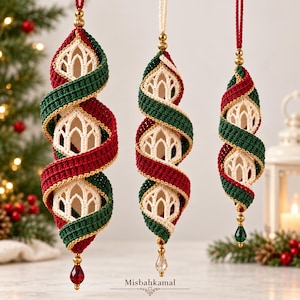 May include: Three hanging ornaments featuring a spiral design of crocheted dark green and deep red yarn wrapped around a cream-colored, open-work crocheted core. Each ornament is topped with a gold bead and finished with a dangling crystal drop.