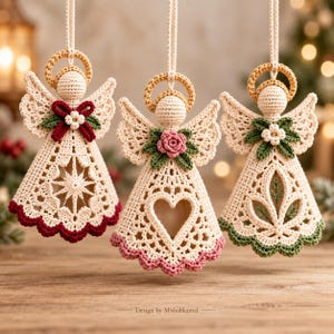 May include: Three hanging crochet angel ornaments in cream yarn, each featuring a gold halo, lace-like skirt, and unique embellishments including a red bow, a pink rose, or green leaves. The text "Design by Misbahkamal" is visible at the bottom.