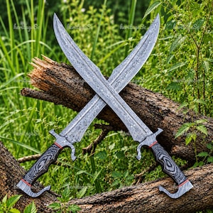 May include: Two crossed swords featuring silver-toned blades with a distinct marbled pattern. The handles are crafted from dark, wood-grain textured material with red accents near the guard and pommel, featuring a curved, hooked design.