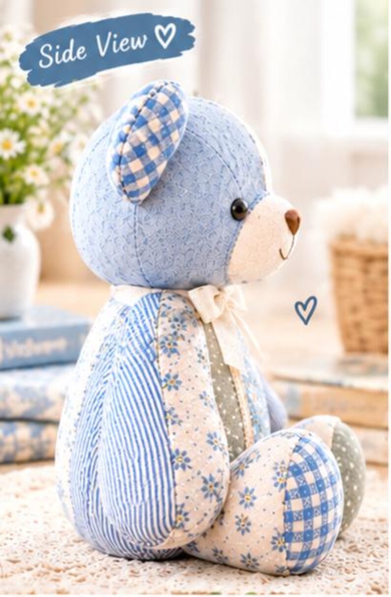 May include: A stuffed bear toy featuring a patchwork design of blue and white fabrics. The bear has a blue gingham ear, a cream-colored muzzle with a brown nose, and a cream ribbon tied around its neck. The body displays floral and striped patterns.