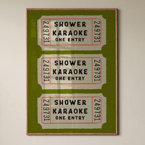 May include: A framed vertical print featuring three stacked ticket stubs in a light grey colour against a dark olive green background. Each ticket displays the black text SHOWER KARAOKE ONE ENTRY and the vertical red number 249731 on both sides.