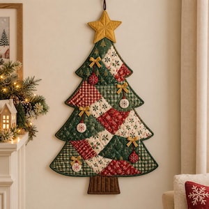 May include: A quilted wall hanging shaped like a Christmas tree, featuring a patchwork design of red, green, and cream fabrics with festive patterns. The tree is topped with a yellow star and decorated with small hanging ornaments and bows.
