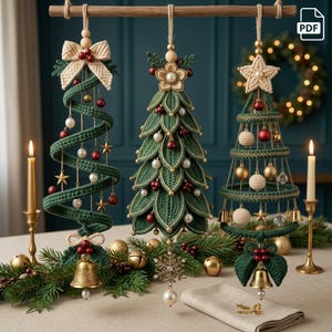 May include: Three hanging Christmas tree ornaments crafted from green yarn. The left is a spiral, the center is leaf-shaped, and the right is a wire-frame cone. All feature gold bells, red and white beads, and decorative bows or stars.