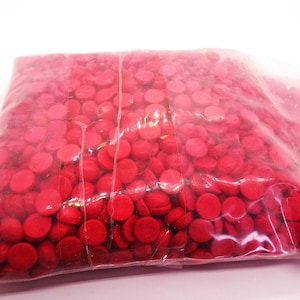 May include: A plastic bag filled with hundreds of small, round, red beads. The beads are uniform in size and shape.