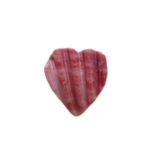 May include: A heart-shaped seashell with a pink and white striped pattern.