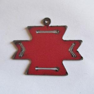 May include: Red metal ornament shaped like a four-pointed star with a loop at the top for hanging.