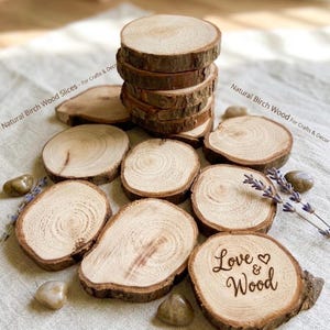May include: A collection of round, light-coloured birch wood slices with natural bark edges. One slice features the laser-engraved text "Love & Wood" with a small heart symbol. The text "Natural Birch Wood Slices - For Crafts & Decor" is visible.