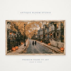 May include: A digital art print titled ANTIQUE BLOOM STUDIO featuring a street scene with two figures in witch costumes walking down a road lined with houses, autumn trees, and glowing jack-o'-lanterns. The text reads PREMIUM FRAME TV ART 3840 X 2160.