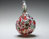 Hand blown blown glass Chrstmas ornament in tones of red, white and green