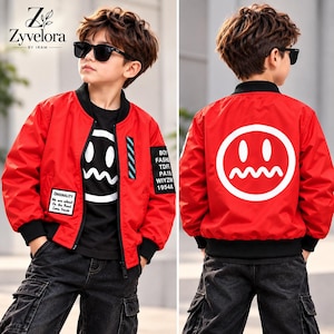 May include: A bright red bomber jacket with black ribbed cuffs and collar. The back features a large white circular graphic with a stylised face. The front includes a black patch with white text and a rectangular blue and black striped accent.