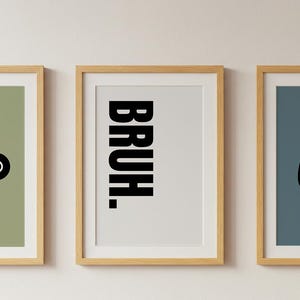 May include: Three framed prints with a gaming theme. One print features black shapes, another says "BRUH" in bold letters, and the third shows a black game controller icon. The frames are light brown, and the backgrounds are green, white, and blue.