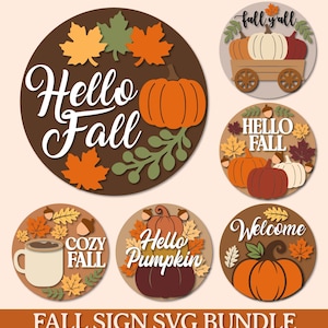 May include: A collection of six circular wooden signs featuring autumn themes. Designs include pumpkins, maple leaves, acorns, and text such as Hello Fall, Hello Pumpkin, Cozy Fall, and Welcome. The color palette consists of orange, brown, and cream.