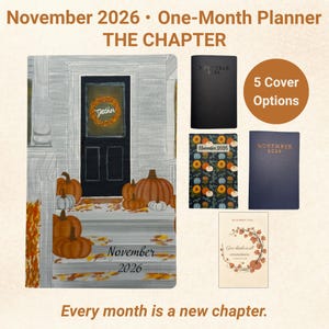 May include: A November 2026 one-month planner titled THE CHAPTER. The main cover features a black door with a wreath and pumpkins on steps. Four additional cover options are shown: black, floral with pumpkins, navy blue, and a cream cover with a wreath.