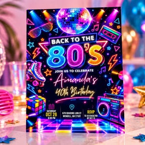May include: A rectangular party invitation card featuring a neon-colored 80s theme with a disco ball, roller skate, Rubik's cube, and boombox. The text reads: BACK TO THE 80'S, JOIN US TO CELEBRATE, Amanda's 40th Birthday, SATURDAY OCT 26 8:00 PM, 678 SOARING LION CT WENDELL, XM 27591, RSVP TO 0123456789 BY OCT 15.