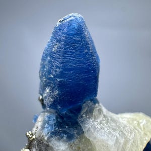 Fluorescent Blue Afghanite Crystal with Pyrite & Calcite Matrix (235 Carat)