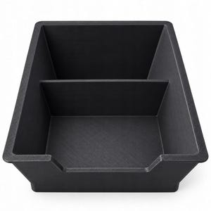 May include: A matte black rectangular storage tray featuring a single internal divider that creates two separate compartments. The tray has a wide, open top design with a lowered front edge for easy access to the contents stored inside.