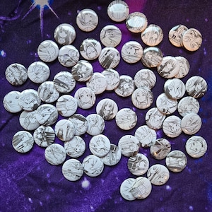 May include: A collection of black and white pinback buttons featuring various anime characters. The buttons are circular and have a shiny silver finish.