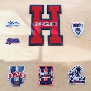 May include: A collection of seven embroidered patches featuring Howard University branding. The set includes a large red and black letter H, two HBCU Made patches, a Howard Bison shield, and three additional patches displaying the Howard Bison logo.