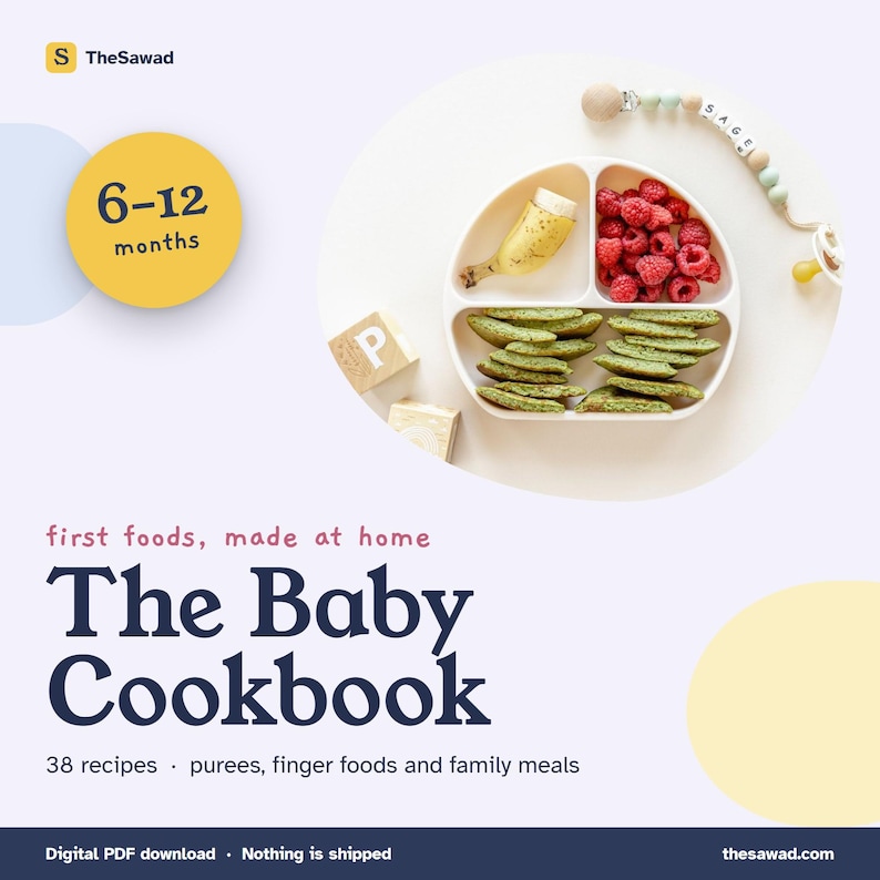 May include: A digital cookbook titled The Baby Cookbook with the subtitle first foods, made at home, 38 recipes, purees, finger foods and family meals. A white divided plate contains a banana, raspberries, and green pancakes.