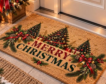 May include: A rectangular tan coir doormat featuring the text MERRY CHRISTMAS in dark green lettering. The design includes three stylized evergreen trees, red bows, pinecones, and small red berries arranged across the surface.