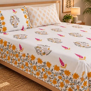May include: A white bed sheet and two matching pillowcases featuring a repeating pattern of orange flowers, grey vines, and small pink floral accents. The design includes a border of dense orange blossoms and grey foliage along the edges.