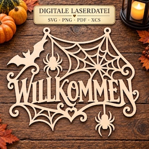 May include: A laser-cut wooden sign featuring the German word WILLKOMMEN in a decorative font, integrated with a spider web design, two spiders, and a bat silhouette. The sign includes two circular holes at the top for hanging purposes.