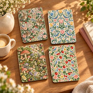 May include: Four rectangular tablets featuring distinct botanical and animal illustrations. One shows rabbits and strawberries, another birds and tulips, a third mushrooms and snails, and the fourth birds and strawberries on a white background.