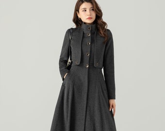 May include: A long, grey, button-up coat with a high collar and a flared skirt. The coat has a double-breasted closure with gold buttons.