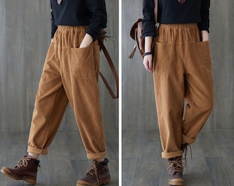 May include: A brown corduroy pants with a high waist and wide legs. The pants have a relaxed fit and are made of a soft, comfortable fabric.