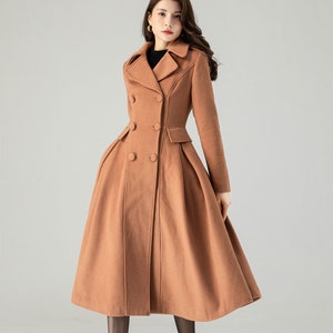 May include: A long, brown, double-breasted coat with a flared skirt. The coat has a classic collar and is made of a soft, warm fabric.