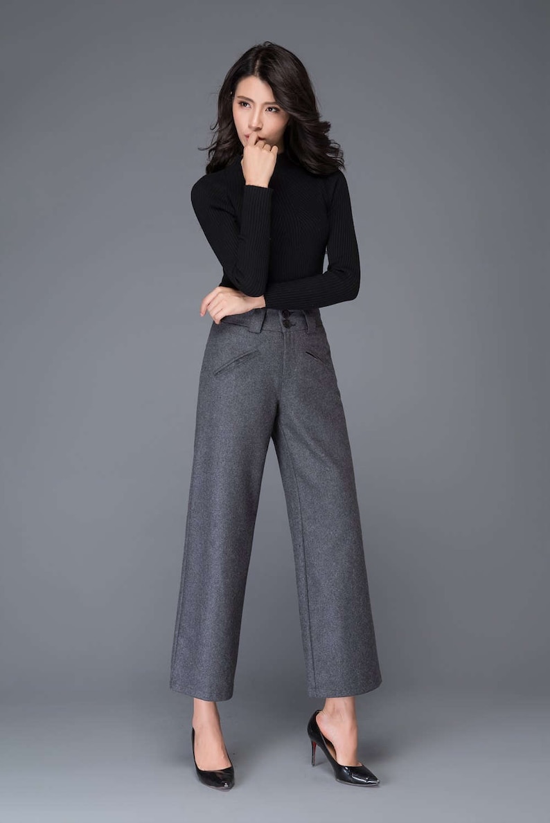 May include: Gray wide-leg pants with a black mock neck shirt.