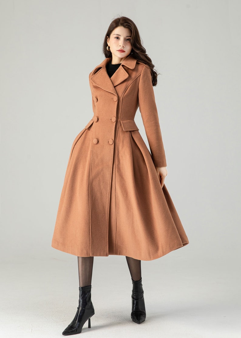 May include: A long, brown, double-breasted coat with a flared skirt. The coat has a classic collar and is made of a soft, warm fabric.