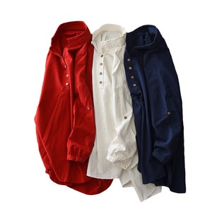 May include: Three long-sleeved shirts in red, white, and blue. Each shirt has a button-up collar and a single button on the front.