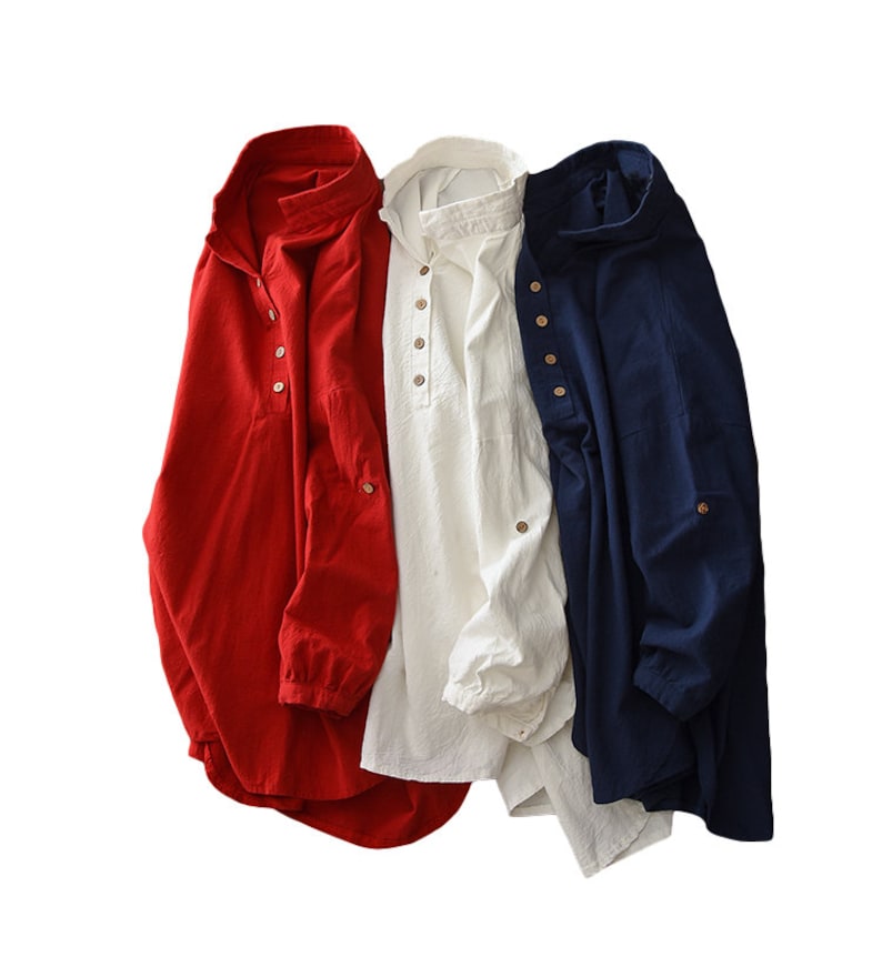 May include: Three long-sleeved shirts in red, white, and blue. Each shirt has a button-up collar and a single button on the front.