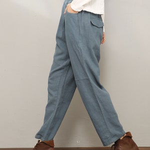 May include: A pair of blue linen pants with a relaxed fit and a drawstring waist. The pants have a casual, comfortable look and are perfect for everyday wear.
