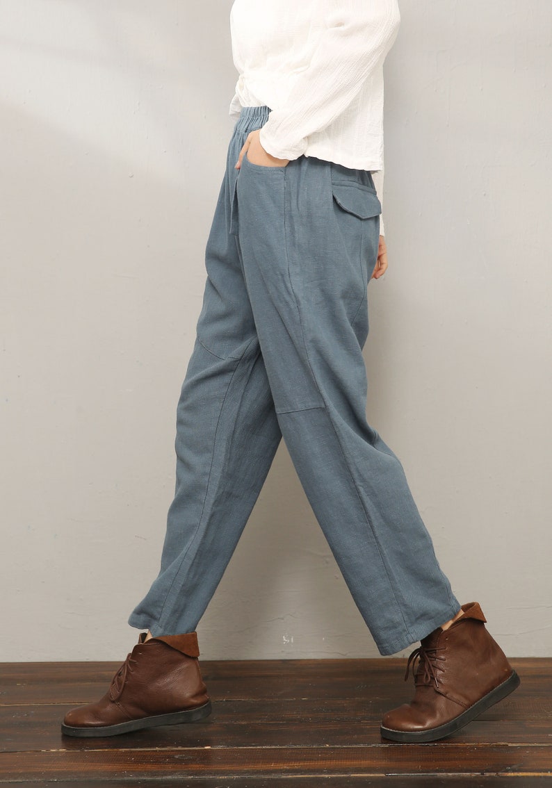 May include: A pair of blue linen pants with a relaxed fit and a drawstring waist. The pants have a casual, comfortable look and are perfect for everyday wear.
